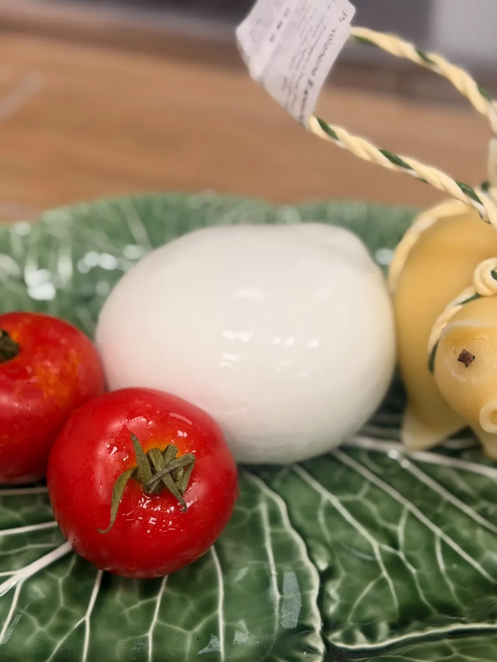 Una mozzarella di bufala su un piatto con i pomodorini